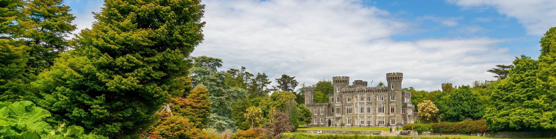 Johnstown Castle & Gardens featuring a pond and heritage architecture