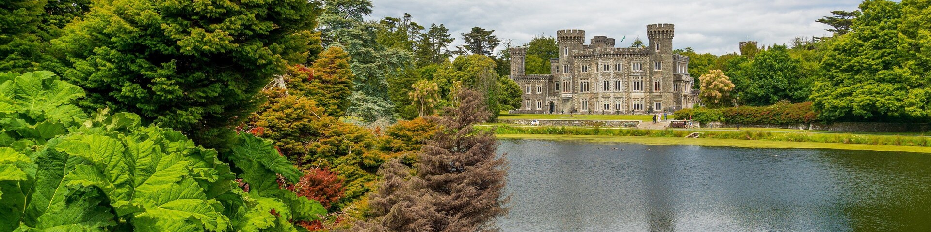 Johnstown Castle & Gardens featuring a pond and heritage architecture