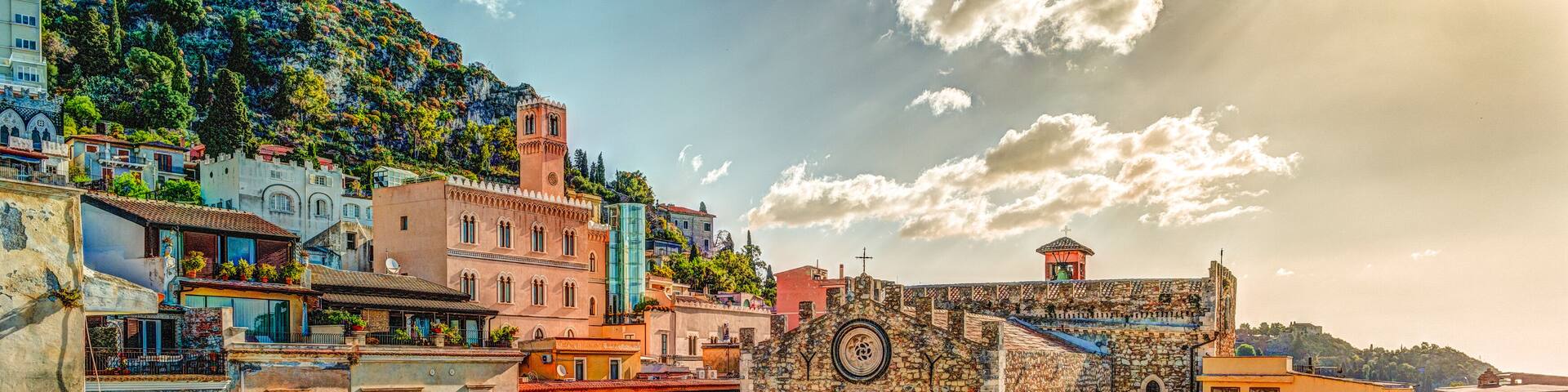 The Duomo in most popular sicilian resort Taormina. Aerial view. Townscape of Taormina with cathedral, square and the hill with other buildings.; Shutterstock ID 559433620; purchase_order: Comps; job: