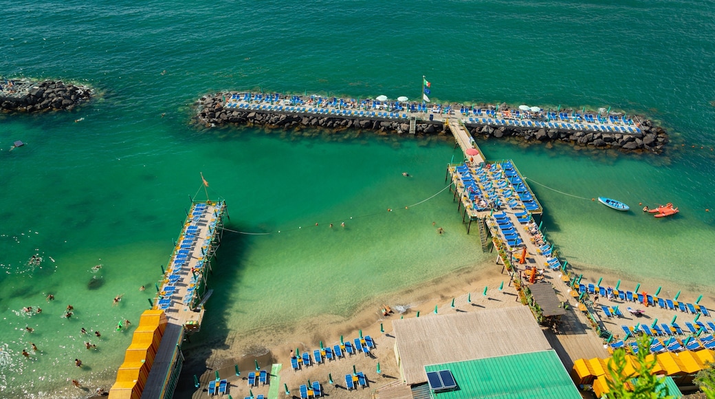 Villa Comunale Park showing general coastal views and swimming as well as a small group of people