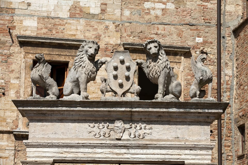 A stone lion sculpture on a building facade.