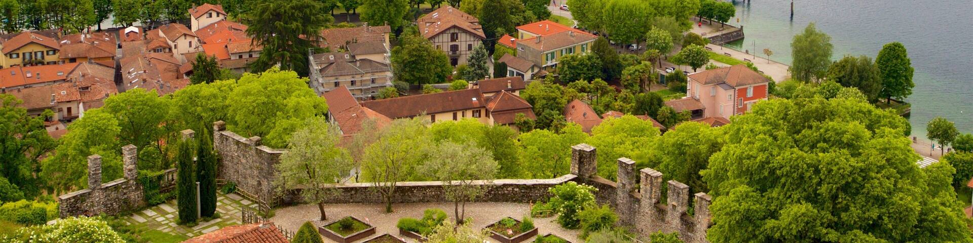 A lakeside town with historic buildings and a castle.