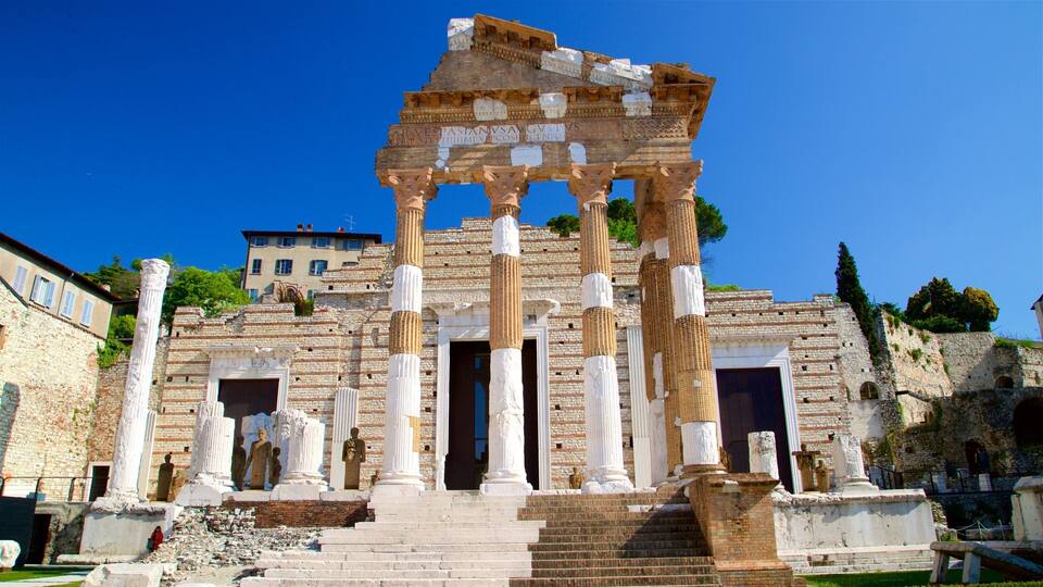 Ancient ruins with columns and a partially intact structure.