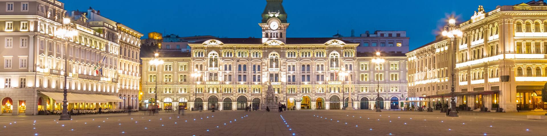The City Hall, Palazzo del Municipio, is the dominating building on Trieste's main square Piazza dell Unita d Italia. Trieste, Italy, Europe. Illuminated city square shot at dusk