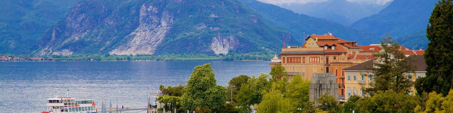 Villa Giulia showing a lake or waterhole, mountains and a small town or village