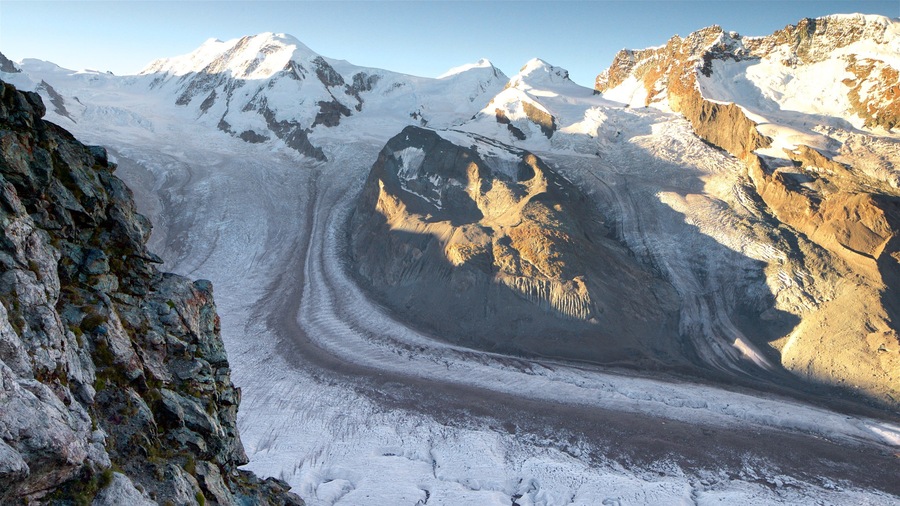 Ein Gletscher mit einer Gletscherspalte und felsigem Gelände.