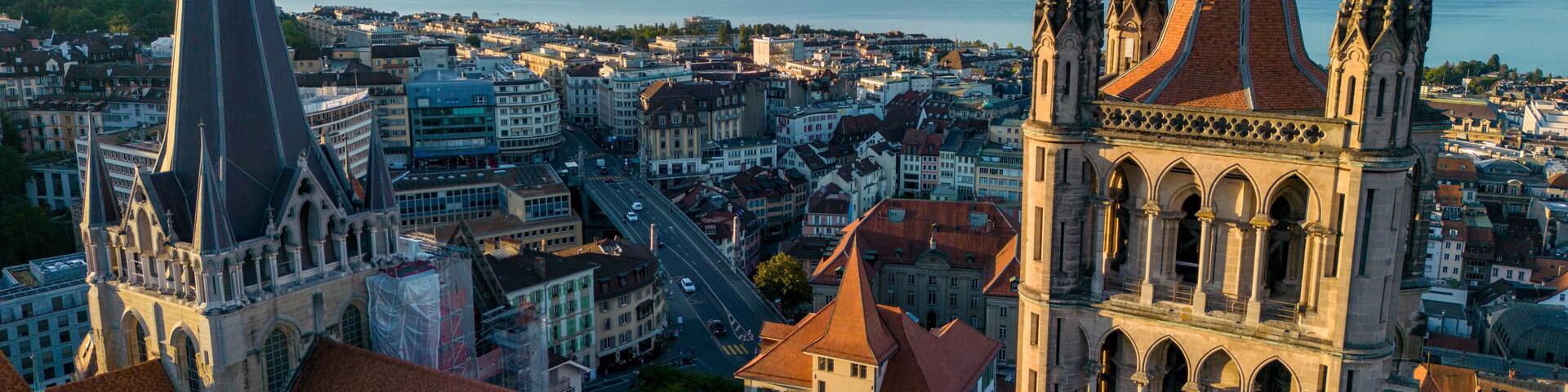 August 22nd 2022, Lausanne, Switzerland. A drone aerial shot of Lausanne cathedral and Lake Geneva at sunrise.