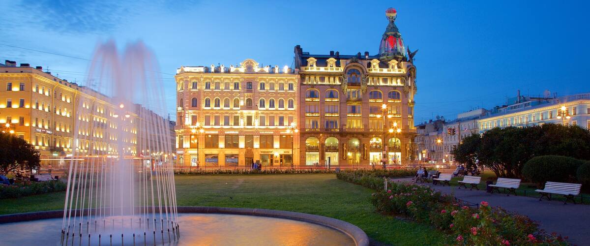 A historic building with ornate architecture and a fountain in the foreground.