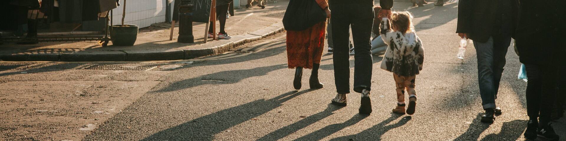 Columbia Road Flower Market featuring a sunset and street scenes as well as a family