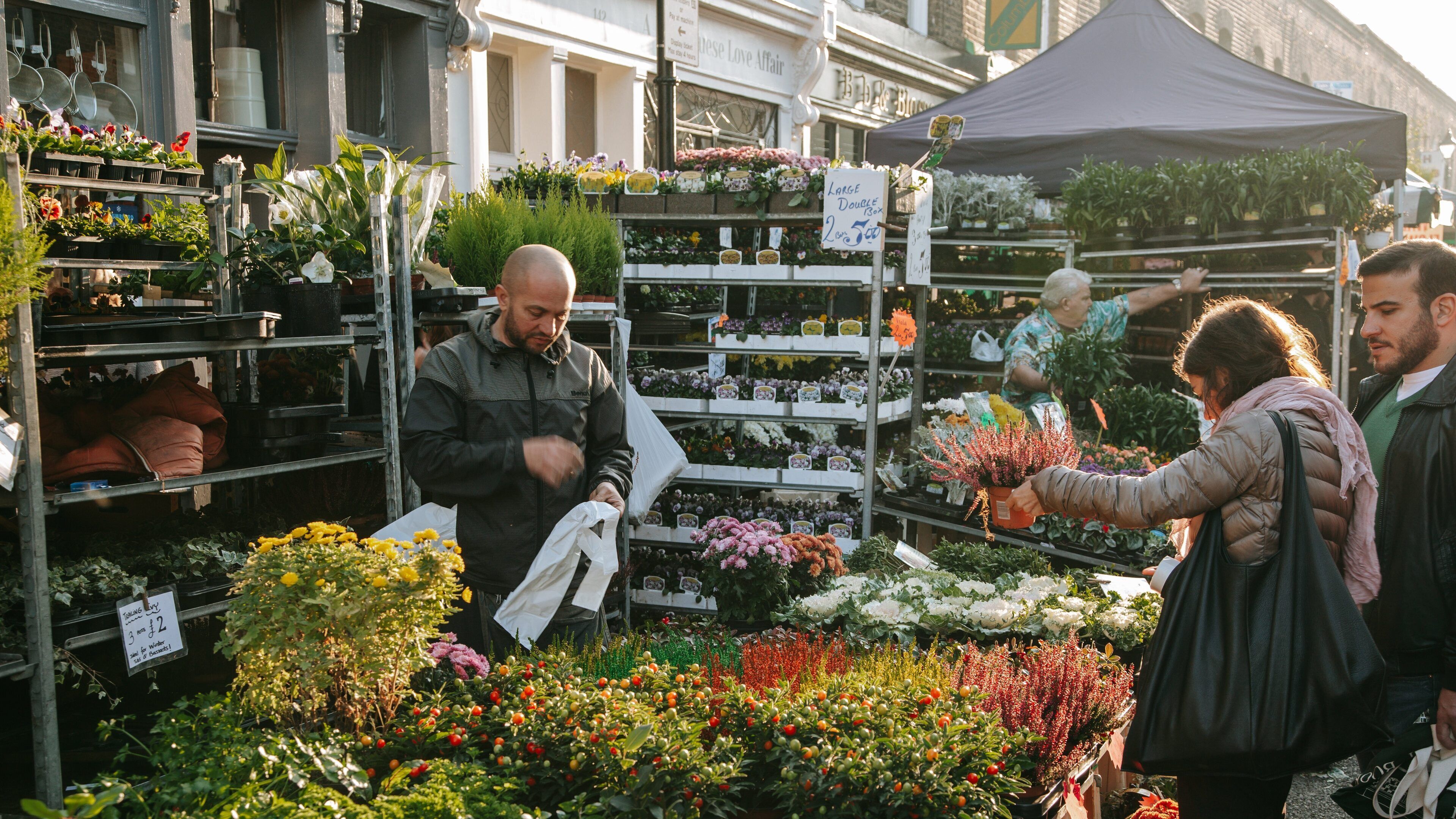 Columbia Road Flower Market showing flowers and markets as well as an individual male