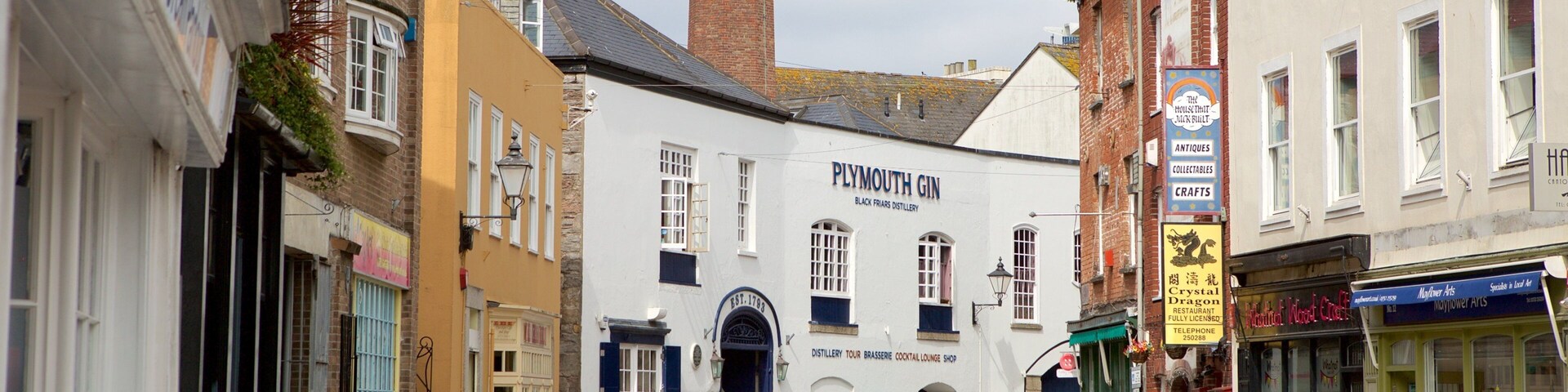 Plymouth which includes a coastal town, signage and street scenes