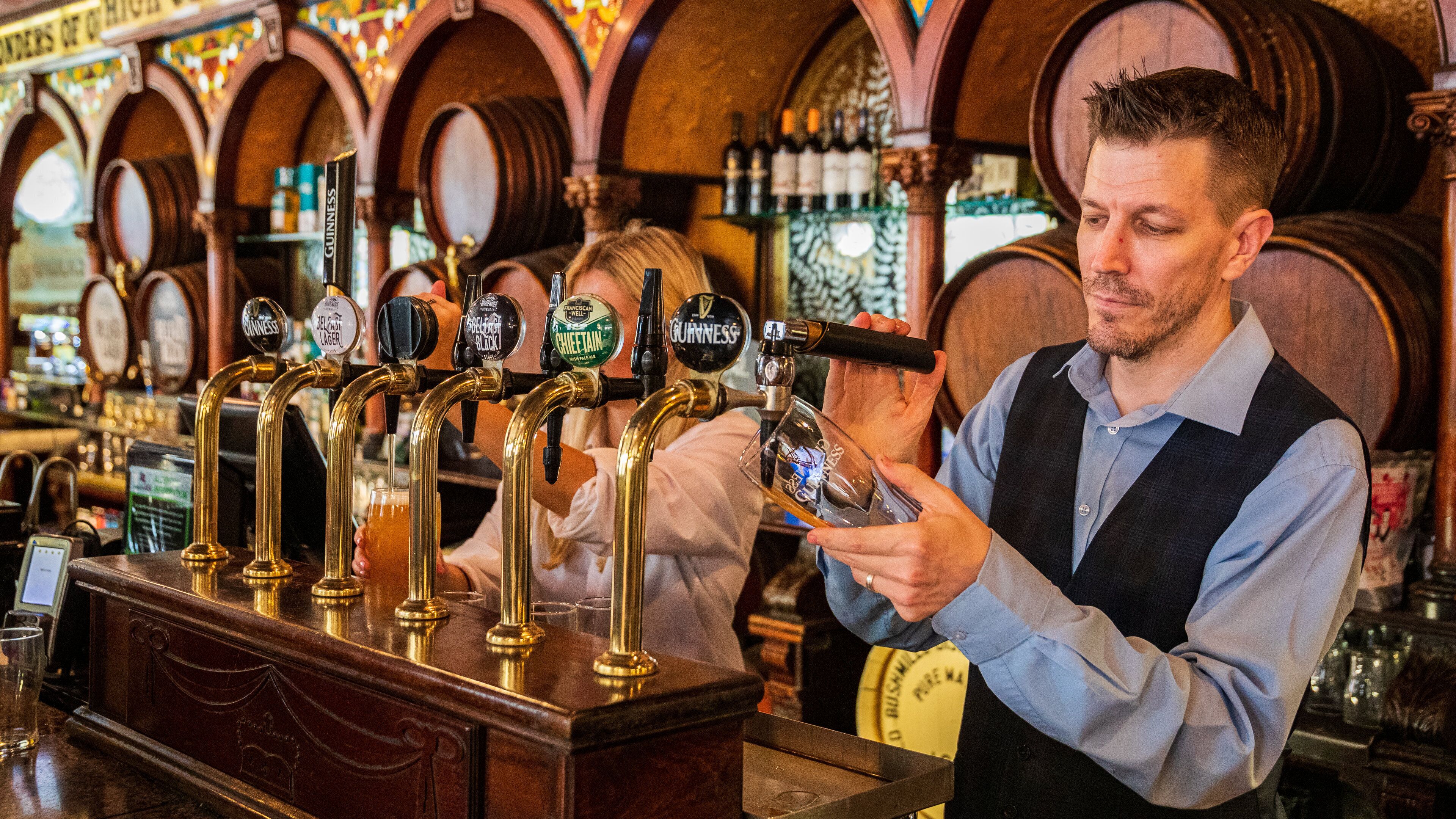Crown Liquor Saloon featuring a bar as well as an individual male