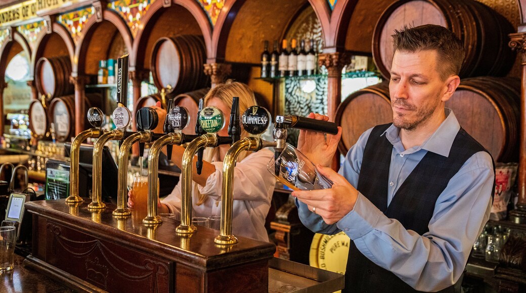 Crown Liquor Saloon featuring a bar as well as an individual male