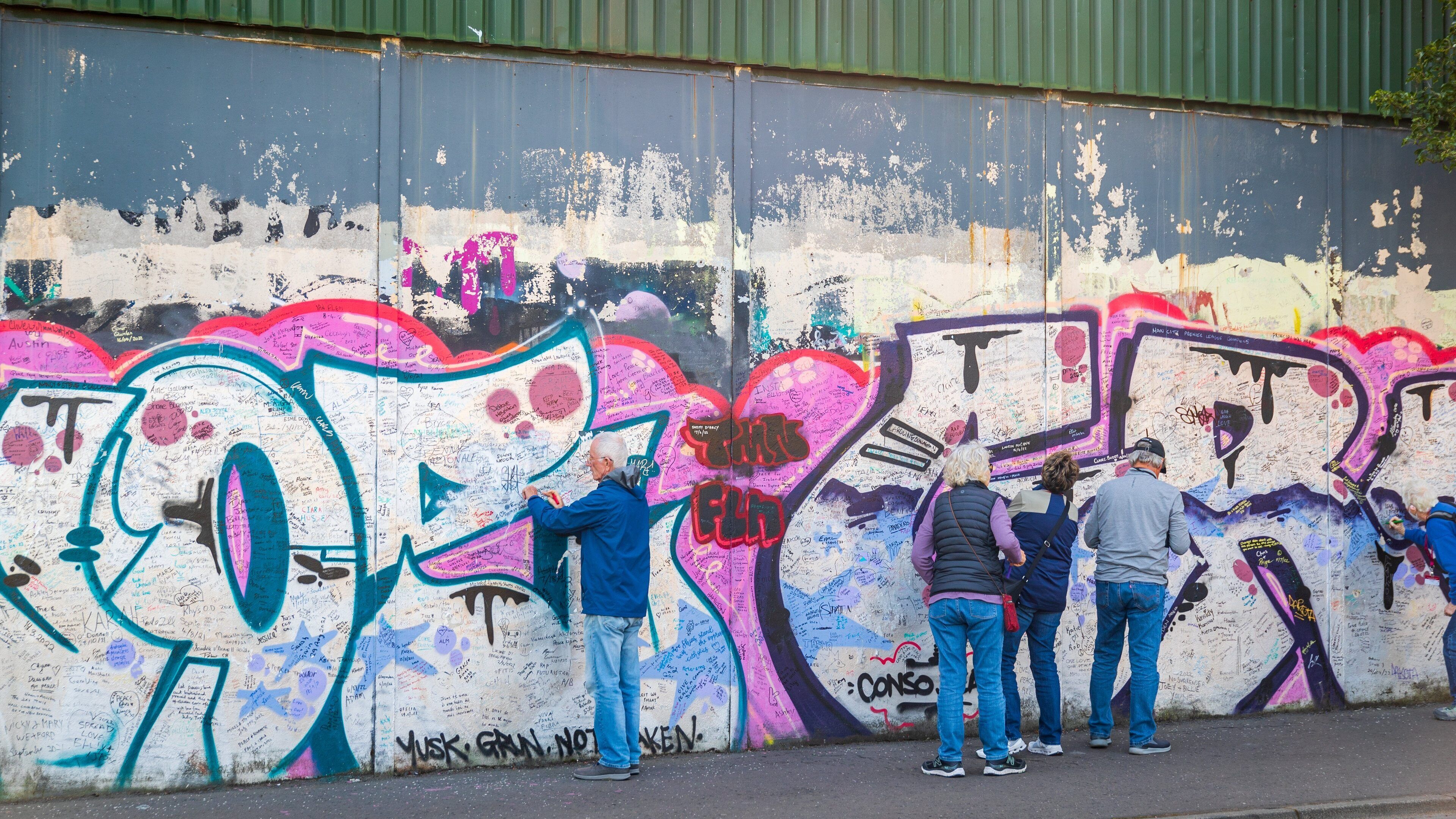 Peace Line showing outdoor art as well as a small group of people