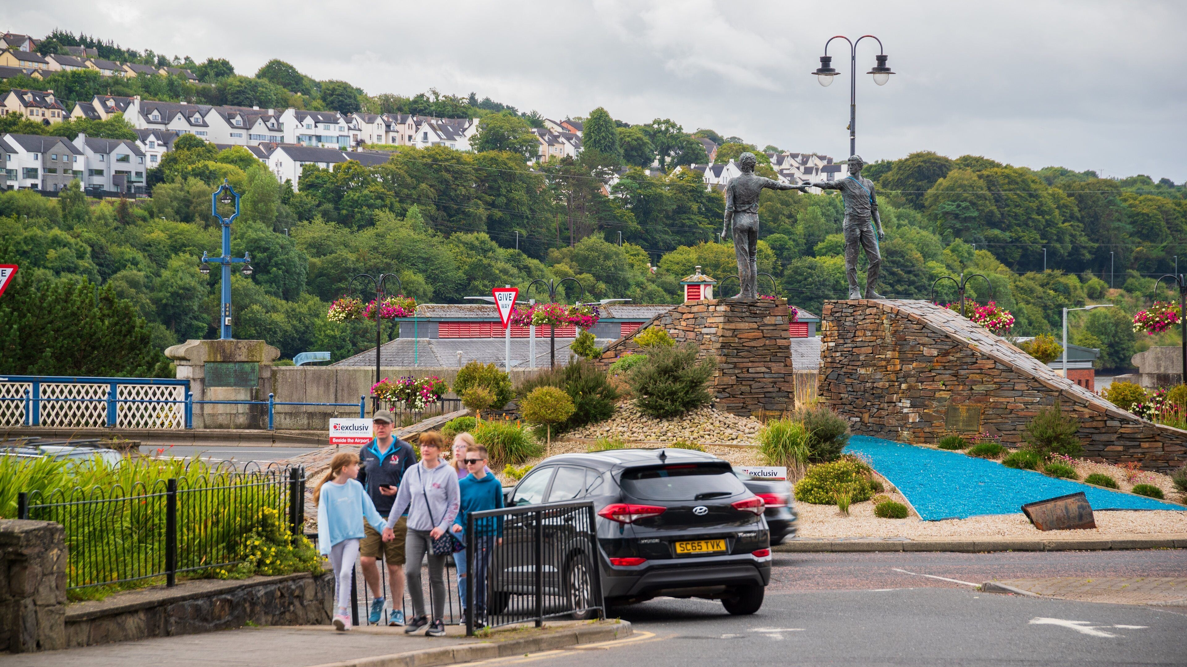 Hands Across the Divide showing street scenes as well as a family