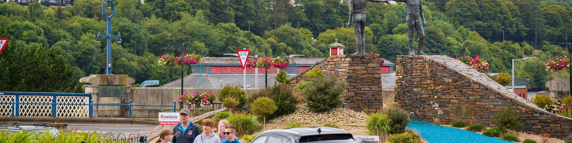 Hands Across the Divide showing street scenes as well as a family