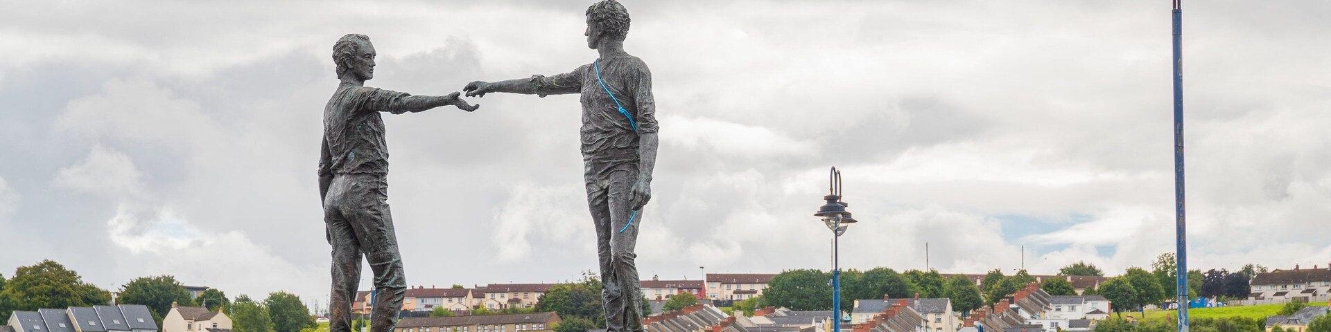Hands Across the Divide featuring a statue or sculpture and outdoor art