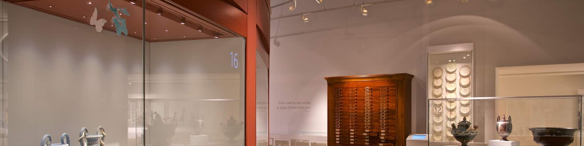 A museum exhibit with ceramic vases and bowls.