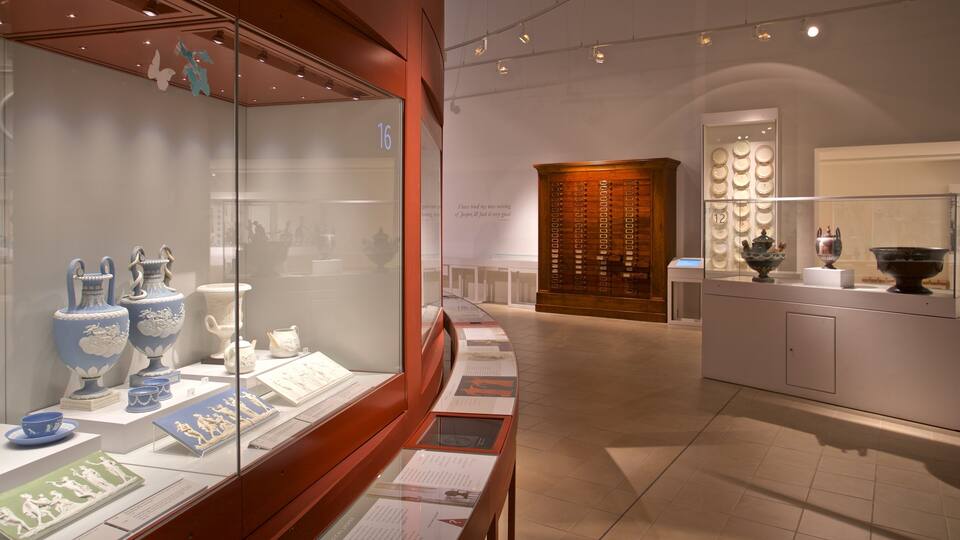 A museum exhibit with ceramic vases and bowls.