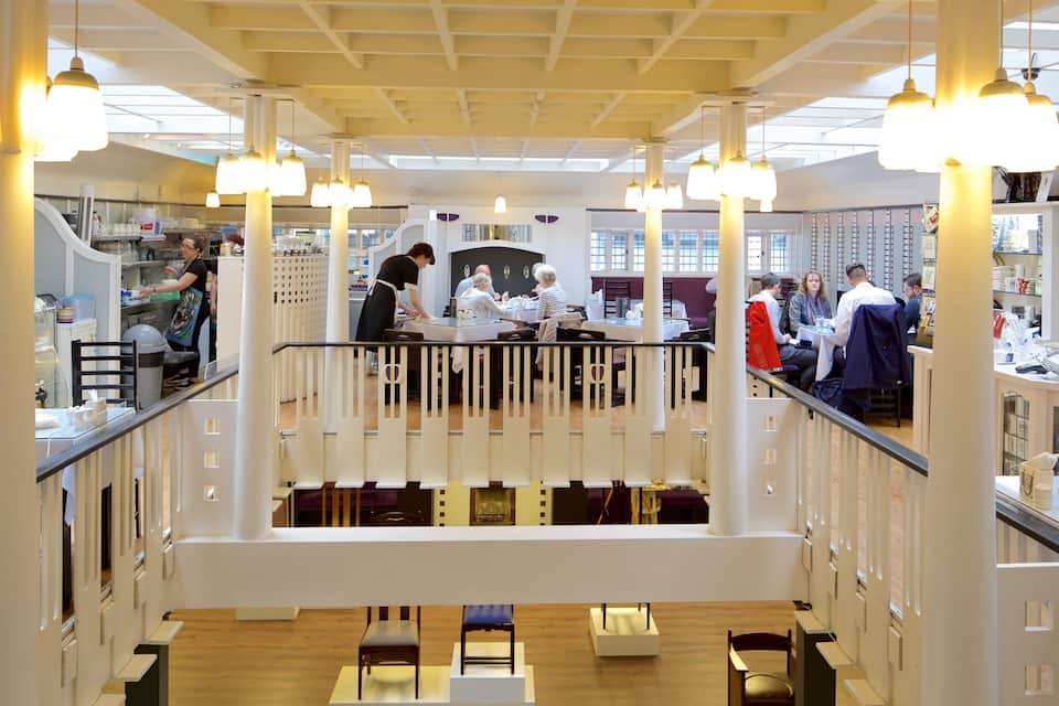 A multi-level shopping mall with various stores and a central seating area.