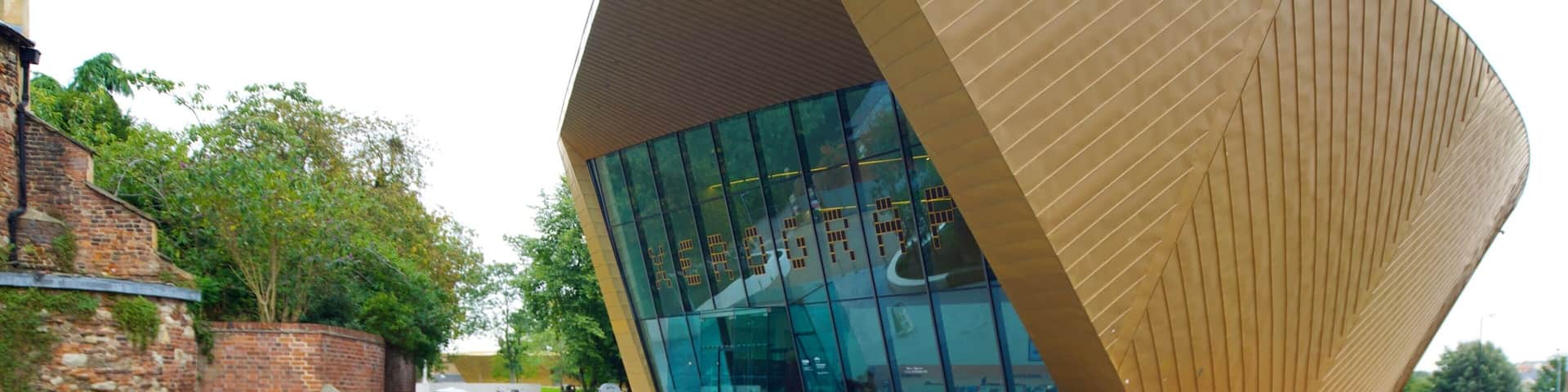 A modern building with a unique angular design and large glass windows.