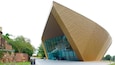 A modern building with a unique angular design and large glass windows.