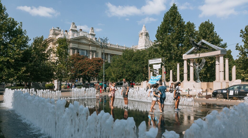 Liberty Square featuring a fountain as well as a small group of people