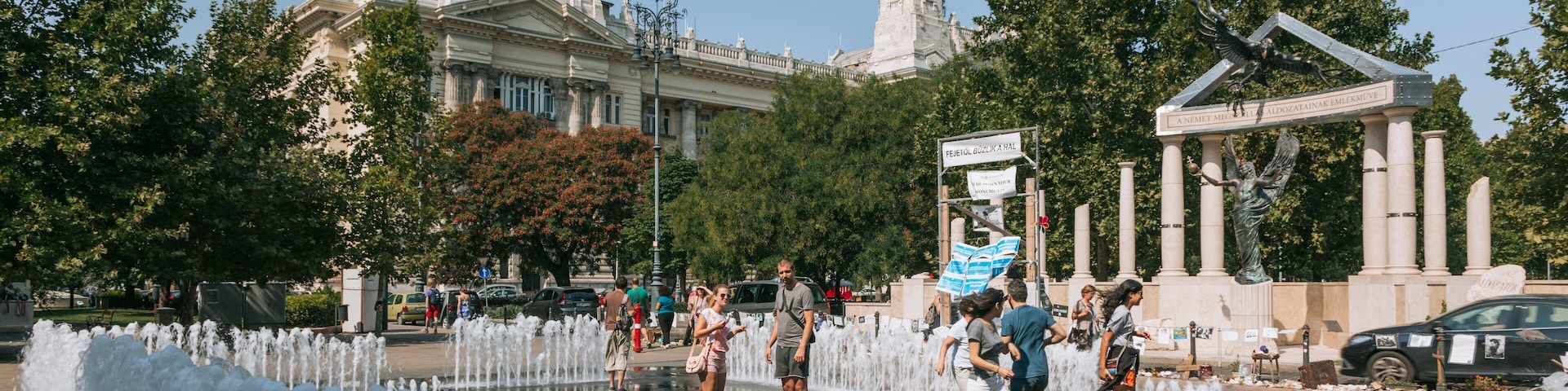 Liberty Square featuring a fountain as well as a small group of people