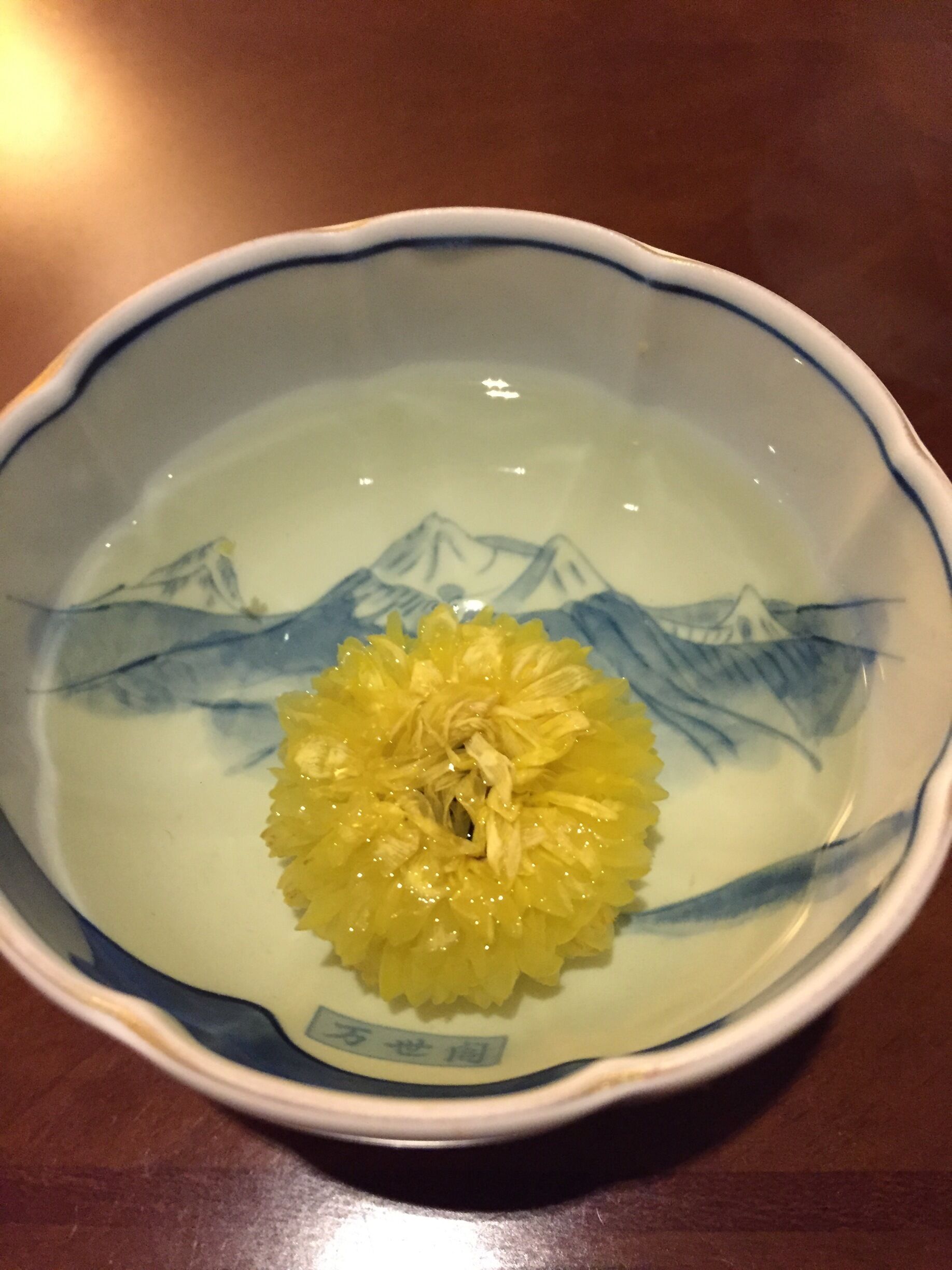 A nice japanese tea cup bearing the picture of Lake Toya. 
Goes very well with Chrysanthemum flower tea.