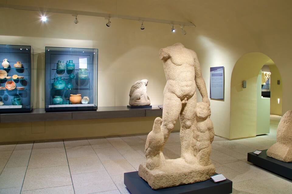 A museum exhibit with ancient pottery and stone sculptures.