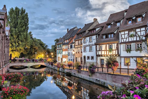 Colorful traditional french houses on the side of river Lauch at the evening in Colmar, France