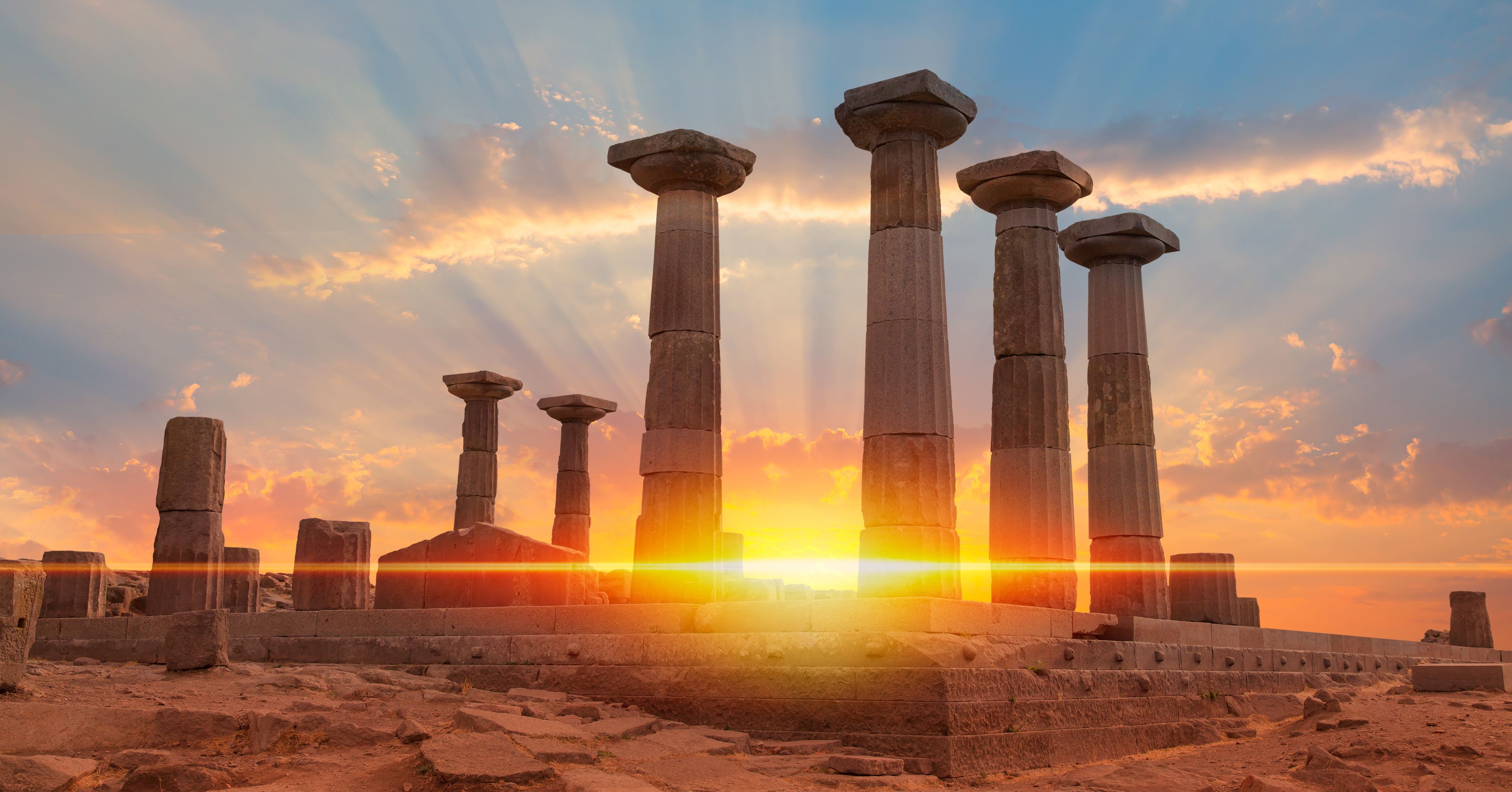 Ancient stone columns at sunset.