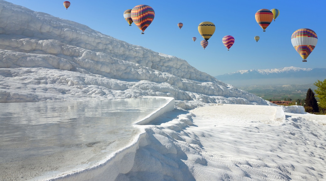 Hot air ballons flying above white Pamukkale, Turkey