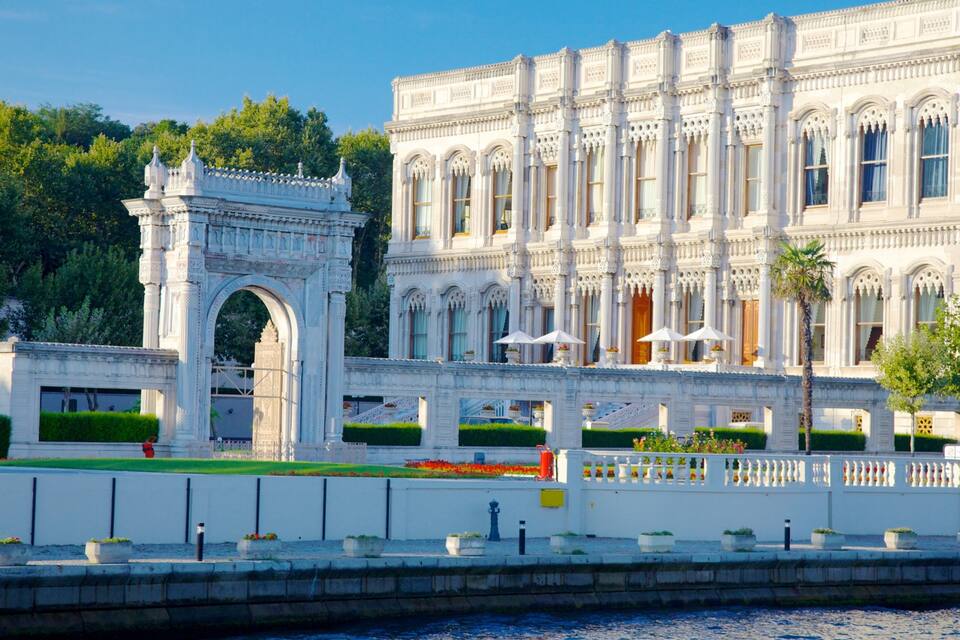 A grand white building with ornate columns and a large archway.