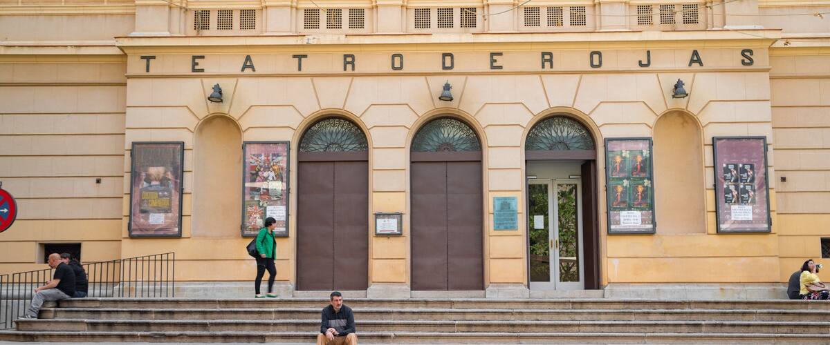 Teatro de Rojas featuring signage as well as an individual male