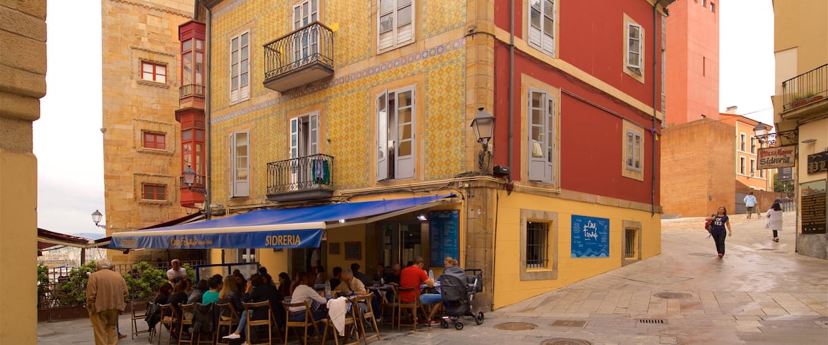 Cimadevilla showing a city and outdoor eating as well as a small group of people