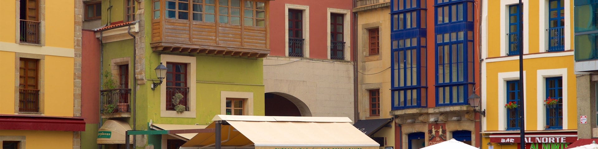 Cimadevilla featuring outdoor eating and a city as well as a small group of people