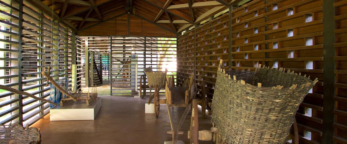 A large, open wooden structure with a high ceiling and metal beams.