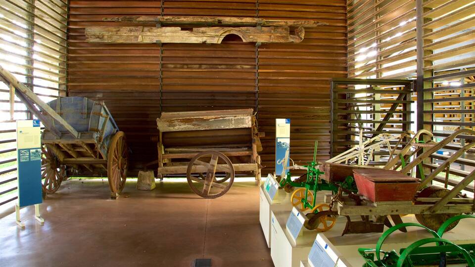 An indoor exhibit with wooden structures, wheels, and mechanical devices.