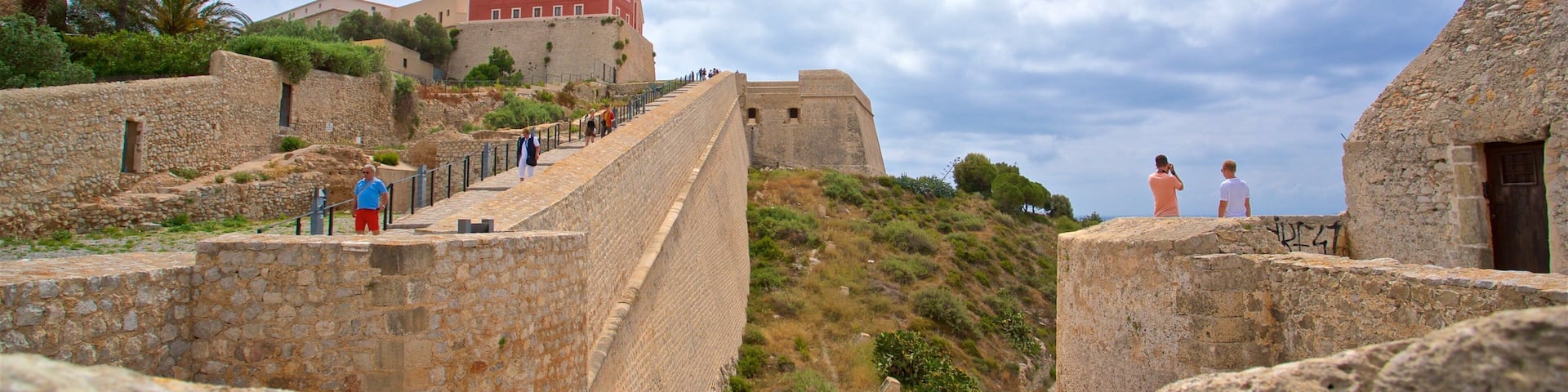 A stone fortification with a staircase leading up to a building.