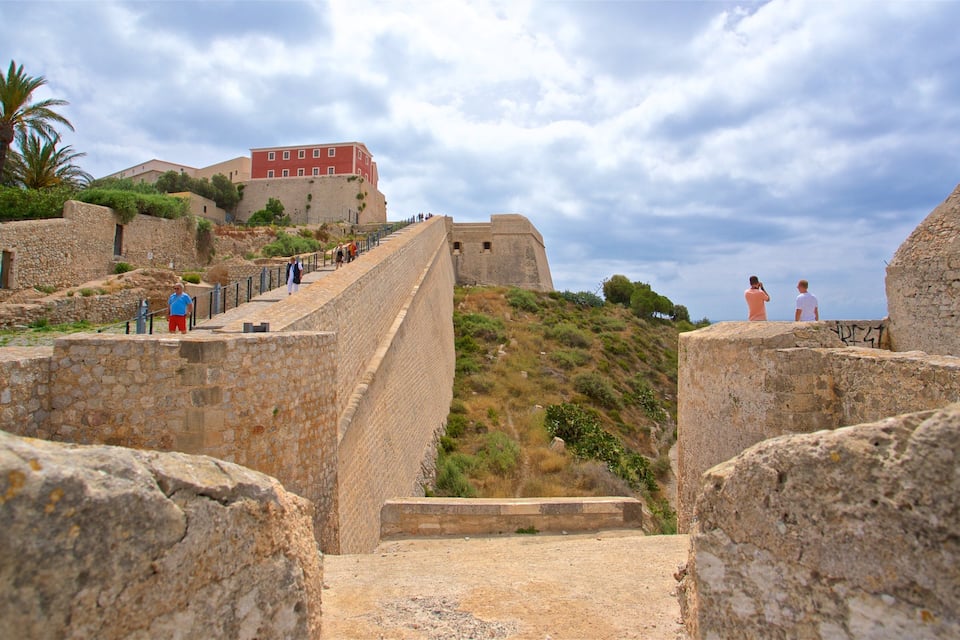 A stone fortification with a staircase leading up to a building.