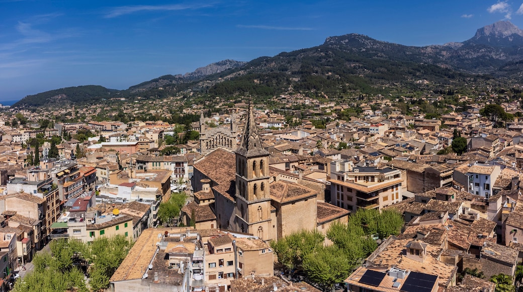 Aerial view of the village with parish of Sant Bartomeu in the foreground and the mountains of the Sóller Valley in the background, Sóller, Mallorca, Balearic Islands, Spain