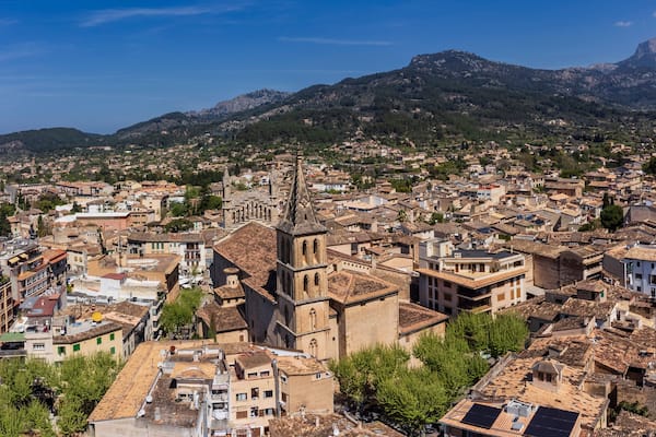 Aerial view of the village with parish of Sant Bartomeu in the foreground and the mountains of the Sóller Valley in the background, Sóller, Mallorca, Balearic Islands, Spain