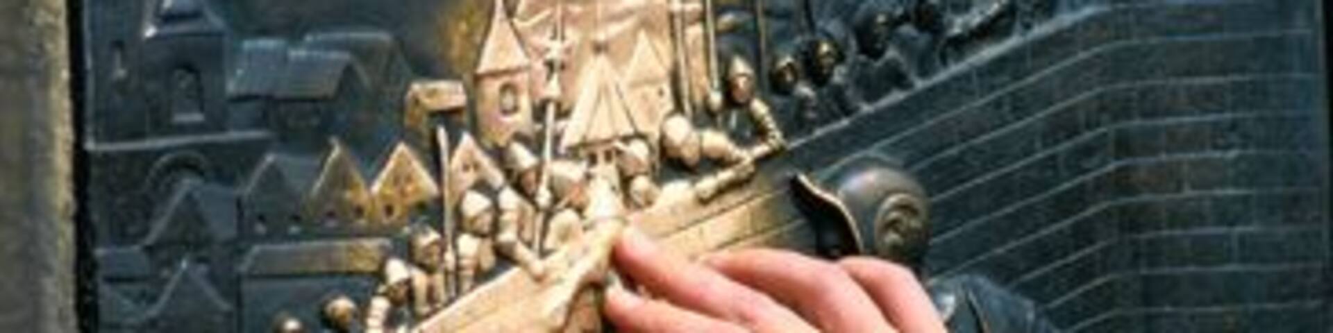 Hand Touching Historic Relief for Luck