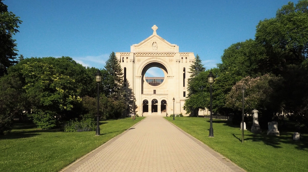 Saint Boniface Cathedral contrasted against a bright blue sky on a sunny day in Winnipeg, Manitoba, Canada. This building serves as the principal church for Eastern Manitoba.