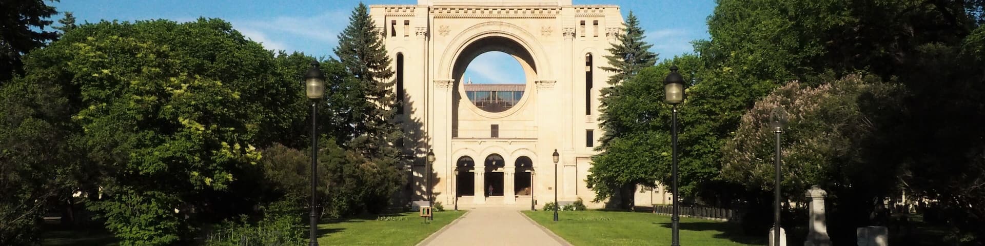 Saint Boniface Cathedral contrasted against a bright blue sky on a sunny day in Winnipeg, Manitoba, Canada. This building serves as the principal church for Eastern Manitoba.