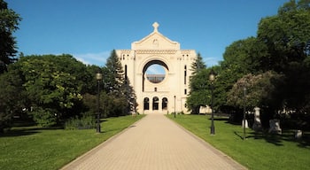 Saint Boniface Cathedral contrasted against a bright blue sky on a sunny day in Winnipeg, Manitoba, Canada. This building serves as the principal church for Eastern Manitoba.