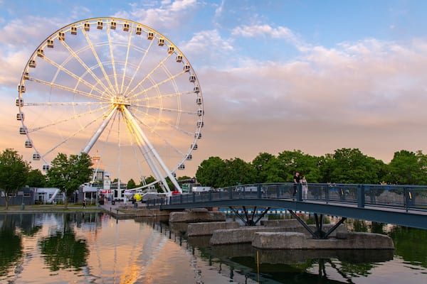 Old Port of Montreal showing a sunset, a river or creek and a bridge