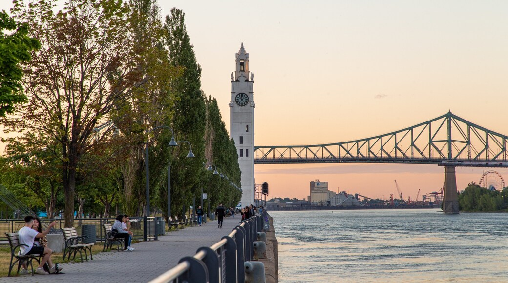 Old Port of Montreal showing a sunset, a river or creek and a bridge