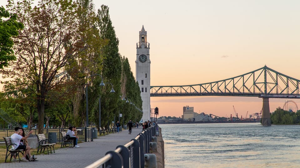 Old Port of Montreal showing a sunset, a river or creek and a bridge